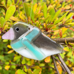 handcrafted fused glass junco in a blue scarf