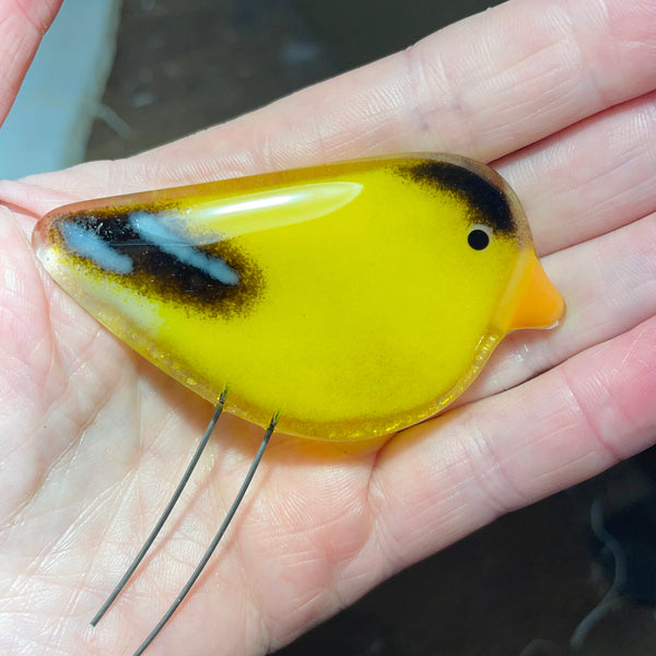 Load image into Gallery viewer, Yellow glass goldfinch chick ornament held in a hand