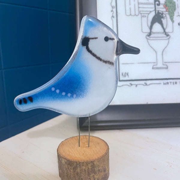 Load image into Gallery viewer, Blue and White Fused Glass Blue Jay on Log in Bathroom