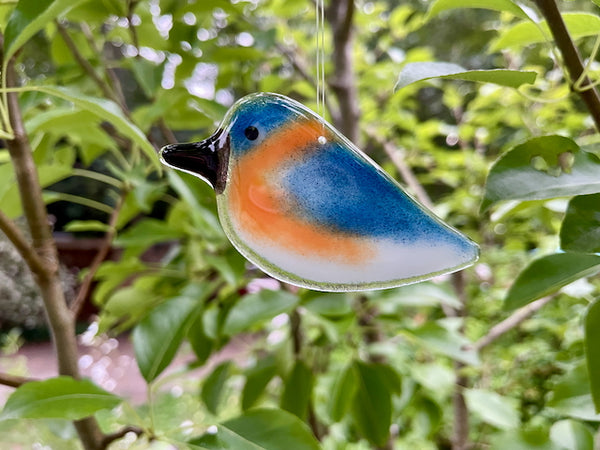 Load image into Gallery viewer, Blue, Peach and White Fused Glass Bluebird Chick Hanging Ornament with a natural background