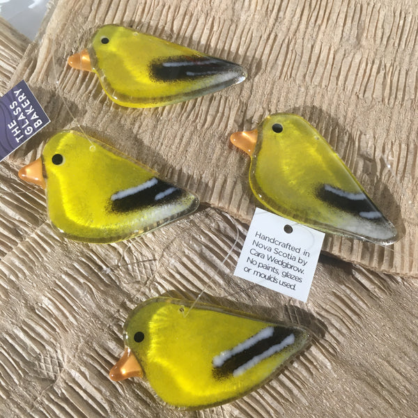 Load image into Gallery viewer, Four yellow glass goldfinch birds with black and white details on a textured surface.