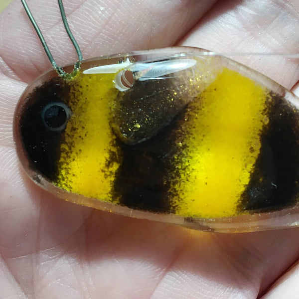 Load image into Gallery viewer, Tiny Black and Gold Glass Honey Bee in the palm of a hand