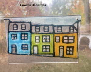 Colorful houses drawing on a glass panel with 'Reverse Orientation' text.