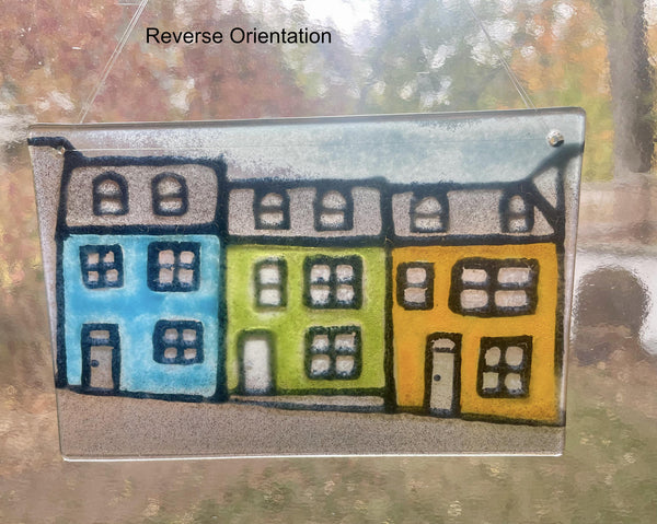Load image into Gallery viewer, Colorful houses drawing on a glass panel with 'Reverse Orientation' text.
