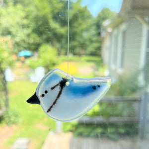 Hanging Pocket Blue Jay bird made from fused glass, hanging in the window. Blue and white, hanging from clear thread.