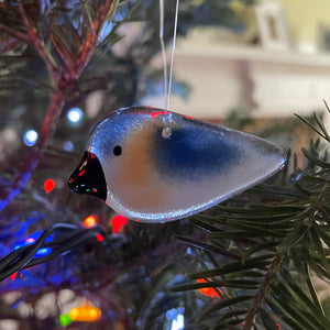 A blue and white Pocket fused glass hanging Bluebird on a Xmas Tree
