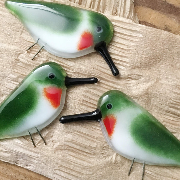 Load image into Gallery viewer, three ruby throated glass hummingbirds are placed on brown Kraft tissue