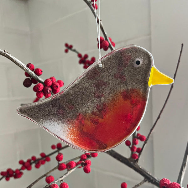 Load image into Gallery viewer, Decorative glass adult robin ornament hanging on a branch with red berries.