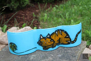 Aqua wave of glass with orange tabby cat and ball of wool