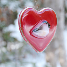 Load image into Gallery viewer, A smooth glossy red glass heart with a chickadee bird on the front
