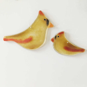 Two fused glass female cardinal hanging birds of different sizes face each other