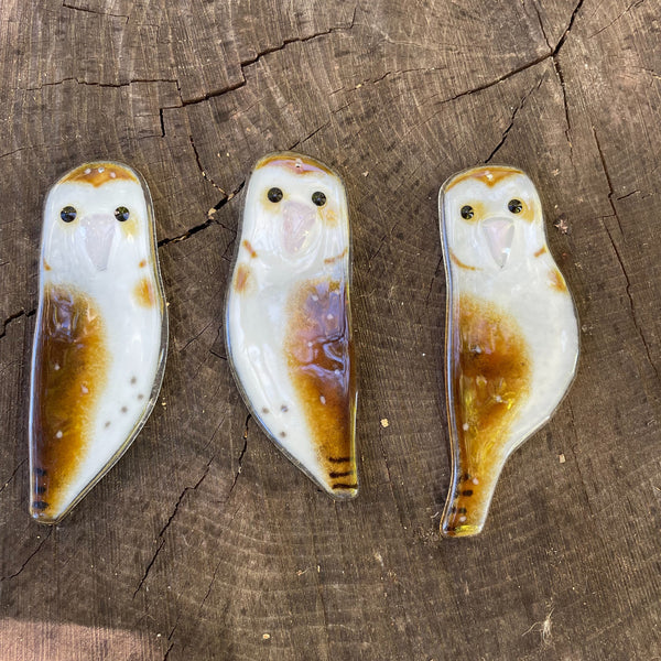 Load image into Gallery viewer, Three owl-shaped fused glass ornaments on a wooden surface
