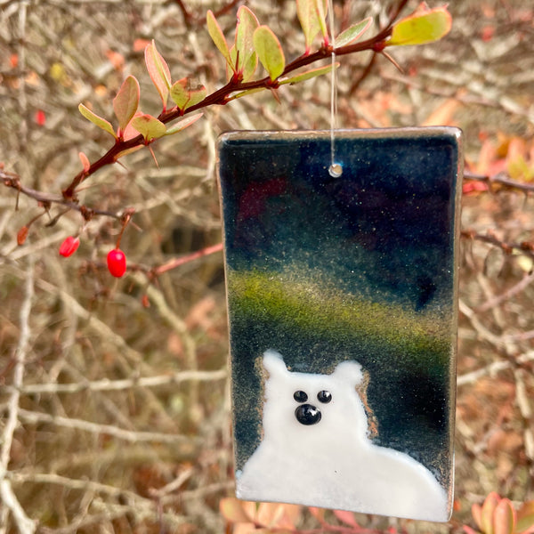Charger l&#39;image dans la galerie, Rectangular fused glass hanging ornament with a polar bear design against a natural background of red berries and branches.
