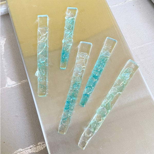 Load image into Gallery viewer, Set of five rectangular turquoise glass icicles on a metal kiln lid background
