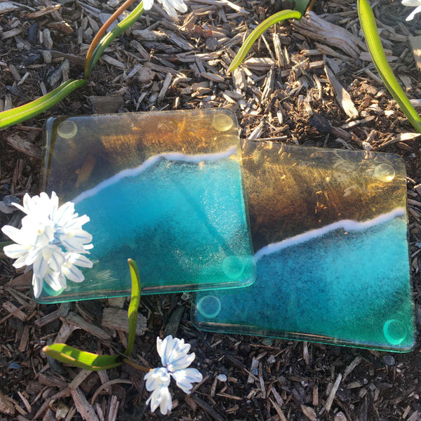 Load image into Gallery viewer, A pair of Fused Glass Turquoise Beach Coasters with white flowers
