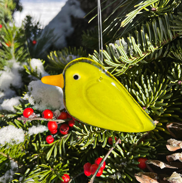 Charger l'image dans la galerie, Yellow fused glass bird ornament on a Christmas tree with red berries and snow.
