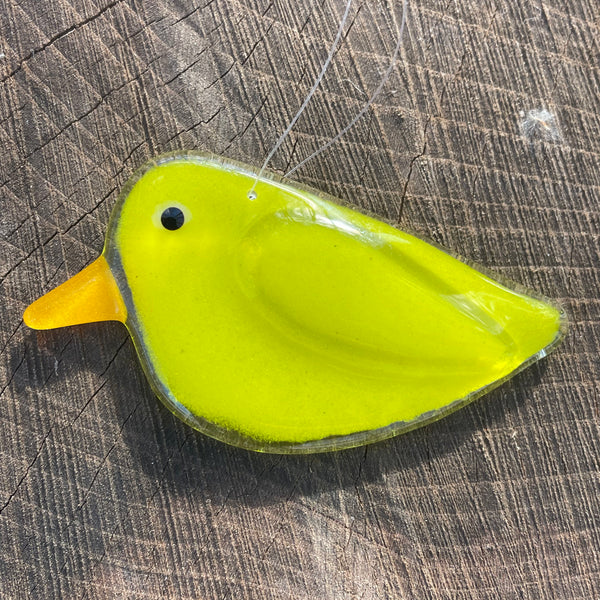 Charger l'image dans la galerie, bright yellow hanging chick on a log surface
