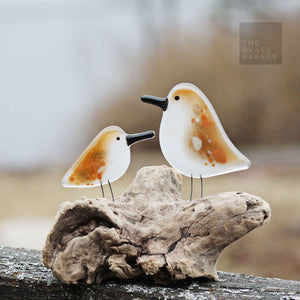 brown and white glass adult and chick sandpiper on driftwood