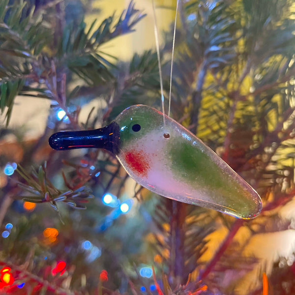 Load image into Gallery viewer, Glass hummingbird ornament on a Christmas tree with blurred lights in the background
