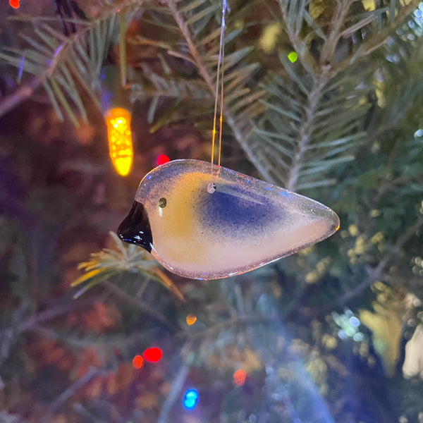 Load image into Gallery viewer, fused glass hanging bluebird ornament dangling from a Christmas tree with fairy lights in the background.

