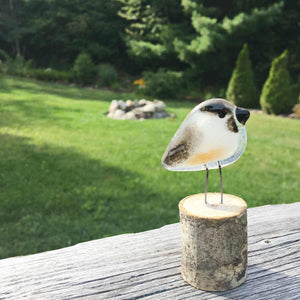 Chickadee Mini Glass Ornament against a natural backdrop