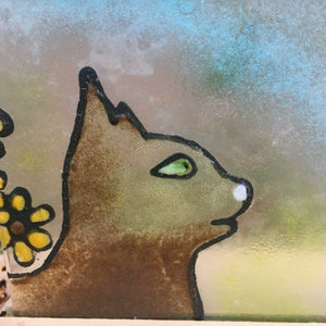 Close up of glass tile featuring a Brown cat with Green Eyes