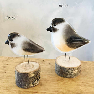 Two fused glass chickadees of different sizes.