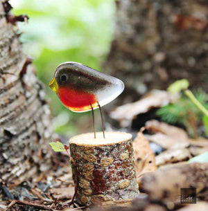 Endearing glass robin in the woods