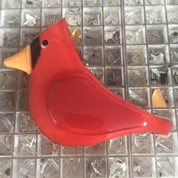Load image into Gallery viewer, A bright red glass cardinal sits on a workbench
