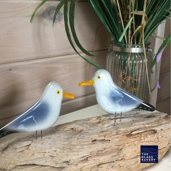 Load image into Gallery viewer, A pair of adult fused glass seagulls perched on driftwood
