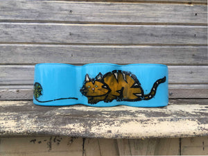Aqua wave of glass with orange and gold coloured tabby cat