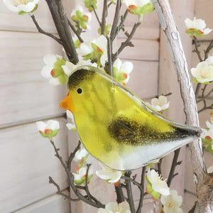 Yellow and Black Glass Goldfinch Bird with blossoms in background