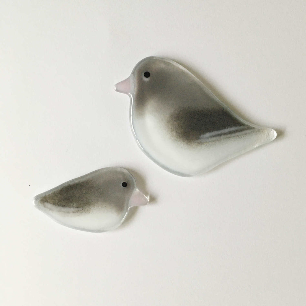 Two different sized white and grey glass hanging Junco bird ornaments