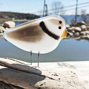 Brown, white and black glass bird that looks like a Piping Plover