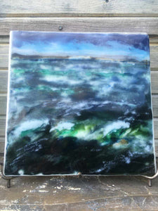 Landscape palette knife painting created from glass powders. The scene is of a turbulent ocean.