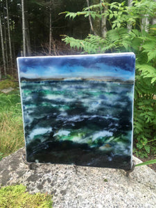 Landscape palette knife painting created from glass powders. The scene is of a turbulent ocean and a hint of the Peggy's Cove peninsula in the background.