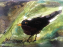 Load image into Gallery viewer, close up of a glass tile featuring a blackbird in a bush
