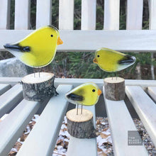 Load image into Gallery viewer, Three charming yellow and black goldfinches made of glass, sit on a garden bench
