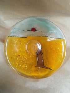amber and aqua glass dish featuring brown and white dog on the beach.