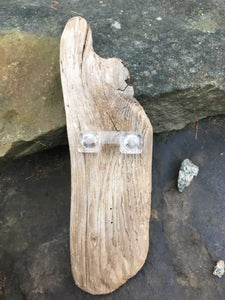An acrylic picture hook on driftwood 